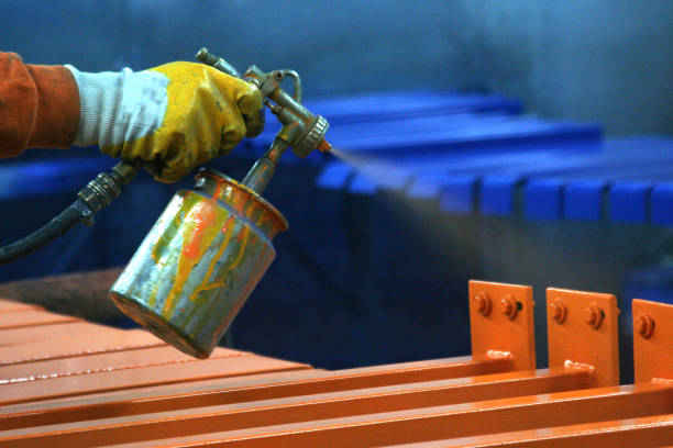 Metal painting worker in factory
